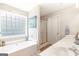 Relaxing bathroom featuring a soaking tub, double vanity and a glass-block window at 2600 Neighborhood Walk, Villa Rica, GA 30180