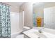 Bathroom featuring a tub with shower, a white sink, mirror and a toilet at 2600 Neighborhood Walk, Villa Rica, GA 30180