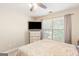 Bedroom showcasing a large window, dresser, and a bed with a patterned comforter at 2600 Neighborhood Walk, Villa Rica, GA 30180