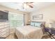 Cozy bedroom featuring a queen size bed, a window, and a dresser with decorations at 2600 Neighborhood Walk, Villa Rica, GA 30180