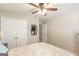Bright bedroom featuring a ceiling fan, double door closet and a blue mirror at 2600 Neighborhood Walk, Villa Rica, GA 30180