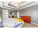 Bright bedroom showcasing a tray ceiling, ceiling fan, and stylish furniture at 2600 Neighborhood Walk, Villa Rica, GA 30180