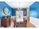 Bright and airy dining room with hardwood floors, wainscoting, and a traditional chandelier, perfect for Gathering gatherings at 2600 Neighborhood Walk, Villa Rica, GA 30180