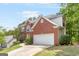 Two-story brick home with a spacious two car garage and well-manicured lawn and landscaping at 2600 Neighborhood Walk, Villa Rica, GA 30180