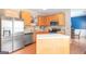 Modern kitchen with stainless steel appliances, wood cabinets, and a functional kitchen island at 2600 Neighborhood Walk, Villa Rica, GA 30180