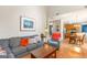 Cozy living room with a comfortable gray sofa, hardwood floors, and view of the kitchen at 2600 Neighborhood Walk, Villa Rica, GA 30180