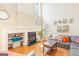 Bright living room with a fireplace, large windows, and comfortable gray sectional sofa at 2600 Neighborhood Walk, Villa Rica, GA 30180