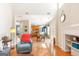 Open-concept living space featuring hardwood floors, fireplace, and view of the kitchen at 2600 Neighborhood Walk, Villa Rica, GA 30180