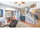 Spacious living room with hardwood floors, staircase, and an open archway that leads to the dining area at 2600 Neighborhood Walk, Villa Rica, GA 30180