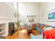 Inviting living room with a fireplace, large windows, and comfortable gray sectional sofa at 2600 Neighborhood Walk, Villa Rica, GA 30180