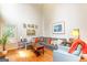 Cozy living room featuring a sectional sofa, hardwood floors, and natural lighting from a window at 2600 Neighborhood Walk, Villa Rica, GA 30180