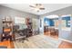 Comfortable home office area that features hardwood floors and is connected to the dining room through an archway at 2600 Neighborhood Walk, Villa Rica, GA 30180
