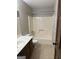 Bathroom featuring a vanity with sink, toilet, and shower-tub combo with tile flooring at 410 Clubland Se Cir, Conyers, GA 30094