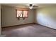 Standard bedroom featuring a ceiling fan, carpet and a window that offers natural light at 410 Clubland Se Cir, Conyers, GA 30094