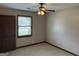 Cozy bedroom featuring neutral tones, a ceiling fan with light, and a window offering natural light at 410 Clubland Se Cir, Conyers, GA 30094