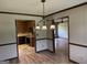 Dining area showcases decorative lighting, flows into kitchen and living room, blending charm and functionality at 410 Clubland Se Cir, Conyers, GA 30094