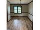 Bright dining room with wood trim, large window and wood floors creates inviting atmosphere at 410 Clubland Se Cir, Conyers, GA 30094
