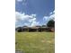 Quaint brick house with a well-maintained lawn, complemented by dark shutters and neatly trimmed shrubbery at 410 Clubland Se Cir, Conyers, GA 30094