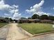 Well-maintained brick home featuring a spacious front yard, a paved driveway, and neat landscaping at 410 Clubland Se Cir, Conyers, GA 30094