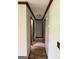Hallway with wood-look floors, neutral walls, and dark trim that leads to several rooms at 410 Clubland Se Cir, Conyers, GA 30094