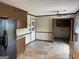 Open kitchen with wood cabinetry, tile floor and access to backyard and laundry area at 410 Clubland Se Cir, Conyers, GA 30094