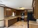 Well-lit kitchen features wood cabinets, modern appliances, and tile flooring for style and functionality at 410 Clubland Se Cir, Conyers, GA 30094