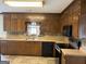 Kitchen features wood cabinets, tile flooring, and modern appliances for a blend of style and functionality at 410 Clubland Se Cir, Conyers, GA 30094