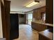 Spacious kitchen with wood cabinetry, tile floor and ample natural light offers an inviting atmosphere at 410 Clubland Se Cir, Conyers, GA 30094