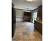 Kitchen features tile floors, wood cabinetry and stainless steel refrigerator adjacent to breakfast nook at 410 Clubland Se Cir, Conyers, GA 30094