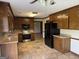 Open concept kitchen featuring wood cabinetry, tile floors, and modern appliances offering functionality and style at 410 Clubland Se Cir, Conyers, GA 30094