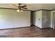 Bright living room featuring wood floors and neutral walls, complemented by ceiling fan and trim at 410 Clubland Se Cir, Conyers, GA 30094