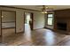 Spacious living room with a brick fireplace and wood-look flooring, seamlessly connected to other living spaces at 410 Clubland Se Cir, Conyers, GA 30094