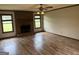 Cozy living room features a brick fireplace, ceiling fan, and wood-look flooring, offering a warm ambiance at 410 Clubland Se Cir, Conyers, GA 30094