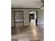 Open-concept living space with wood-look flooring and access to a kitchen, creating an inviting atmosphere at 410 Clubland Se Cir, Conyers, GA 30094