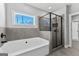 Bright bathroom featuring a tub, stand up shower, and modern finishes at 296 Deer Creek Run # 11, Moreland, GA 30259