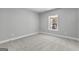 Bedroom with neutral-toned walls, carpeted floors, and window at 296 Deer Creek Run # 11, Moreland, GA 30259