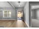 Inviting foyer with light wood floors, an open floor plan, and natural light streaming through the windows at 296 Deer Creek Run # 11, Moreland, GA 30259