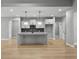 Kitchen featuring gray cabinets, an island, and stainless steel appliances at 296 Deer Creek Run # 11, Moreland, GA 30259