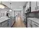 Modern kitchen with white cabinets, black hardware, granite countertops, and stainless steel appliances at 296 Deer Creek Run # 11, Moreland, GA 30259