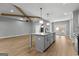 Bright, open kitchen featuring an island, modern light fixtures, and stainless steel appliances at 296 Deer Creek Run # 11, Moreland, GA 30259