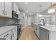 Bright kitchen with a marble countertop island, stainless steel appliances and gray cabinetry at 296 Deer Creek Run # 11, Moreland, GA 30259