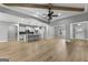 Spacious open-concept living area with wood-look floors, a kitchen island, and pendant lighting at 296 Deer Creek Run # 11, Moreland, GA 30259