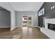 Open-concept living room with hardwood floors, a fireplace, and glass doors to the backyard at 296 Deer Creek Run # 11, Moreland, GA 30259