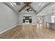 Bright and airy living area with wood-look floors, wooden beam accents, and a view to the fireplace at 296 Deer Creek Run # 11, Moreland, GA 30259