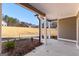 Covered patio with white pillars, overlooking a spacious backyard with lush, natural surroundings at 296 Deer Creek Run # 11, Moreland, GA 30259
