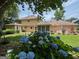 Expansive backyard with mature trees, patio furniture, and an enclosed sunroom at 404 Windsor Way, Peachtree City, GA 30269