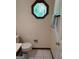 Classic bathroom with decorative window, toilet, and towel rack at 404 Windsor Way, Peachtree City, GA 30269
