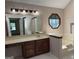 Bathroom features a wide vanity with ample counter space, an octagon window, and tile flooring at 404 Windsor Way, Peachtree City, GA 30269