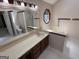 Bathroom featuring a wide vanity, octagon window view, and combined shower and toilet area at 404 Windsor Way, Peachtree City, GA 30269