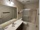 Full bathroom, featuring a wallpapered design with a wide vanity, shower, and toilet area at 404 Windsor Way, Peachtree City, GA 30269